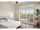 Bright bedroom featuring hardwood floors, a ceiling fan, and a sliding door to the patio at 41903 N Golf Crest Rd, Anthem, AZ 85086