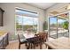 Dining area with natural light, views of the pool, and access to the outdoor patio space at 41903 N Golf Crest Rd, Anthem, AZ 85086
