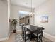 Cozy dining room with a rustic table, modern chandelier, and natural light at 41903 N Golf Crest Rd, Anthem, AZ 85086
