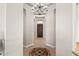Elegant foyer with decorative tile flooring and a chandelier, leading to the main entrance at 41903 N Golf Crest Rd, Anthem, AZ 85086