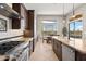 Open kitchen featuring granite countertops, stainless steel appliances, and a view to the outdoor pool area at 41903 N Golf Crest Rd, Anthem, AZ 85086