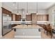 Spacious kitchen featuring rich wood cabinetry, stainless steel appliances, and granite countertops at 41903 N Golf Crest Rd, Anthem, AZ 85086