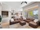 Expansive living room connected to the kitchen and featuring a large sectional sofa and backyard views at 41903 N Golf Crest Rd, Anthem, AZ 85086