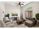 Comfortable living room with a large window, stylish decor, and a ceiling fan at 41903 N Golf Crest Rd, Anthem, AZ 85086