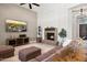 Comfortable living room with a stone fireplace, TV, and cozy seating for Gathering gatherings at 41903 N Golf Crest Rd, Anthem, AZ 85086