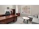 Home office with hardwood floors, a ceiling fan, a large window, and built-in shelving at 41903 N Golf Crest Rd, Anthem, AZ 85086