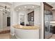 Granite wet bar located between the dining area and the kitchen, stainless steel appliances, and glass cabinets at 41903 N Golf Crest Rd, Anthem, AZ 85086