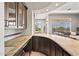 Wet bar with granite countertop, cabinetry, and an open layout to the dining and living spaces at 41903 N Golf Crest Rd, Anthem, AZ 85086
