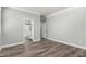 Spacious bedroom featuring wood-look floors and an ensuite bathroom with a shower at 41903 W Rojo St, Maricopa, AZ 85138
