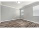 Bedroom features neutral colors, wood floors and bright natural light at 41903 W Rojo St, Maricopa, AZ 85138