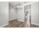 Bright dining room with wood floors and a modern chandelier at 41903 W Rojo St, Maricopa, AZ 85138