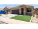 Charming single-story home featuring a desert landscape, brown garage door, and tiled roof at 41903 W Rojo St, Maricopa, AZ 85138