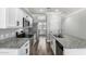 Modern kitchen features stainless steel appliances, granite countertops, and white cabinets at 41903 W Rojo St, Maricopa, AZ 85138