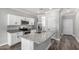 Kitchen features an island, granite countertops, white cabinets, and stainless steel appliances at 41903 W Rojo St, Maricopa, AZ 85138