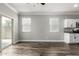 Bright open concept living room with wood floors, lots of windows, and backyard access at 41903 W Rojo St, Maricopa, AZ 85138