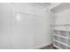 A walk-in closet offers ample storage with white shelving units at 41903 W Rojo St, Maricopa, AZ 85138