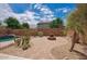 Backyard with a brick fire pit and desert landscaping at 4413 W Phalen Dr, New River, AZ 85087