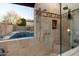 Luxurious bathroom with a view to the backyard pool offers a spacious walk-in shower with neutral tile at 4413 W Phalen Dr, New River, AZ 85087