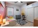 Charming bedroom featuring a fun accent wall, wood-look floors, and ample storage space for a sanctuary at 4413 W Phalen Dr, New River, AZ 85087