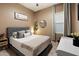 Comfortable bedroom showcasing neutral walls and wood-look floors, offering a cozy space for relaxation at 4413 W Phalen Dr, New River, AZ 85087