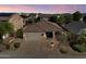 Exterior view of this one story house at twilight at 4413 W Phalen Dr, New River, AZ 85087