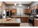 Kitchen with stainless steel appliances, granite countertops, and ample cabinet space for storage at 4413 W Phalen Dr, New River, AZ 85087