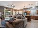 Open-concept living room featuring modern furniture, a ceiling fan, and a view of the backyard at 4413 W Phalen Dr, New River, AZ 85087