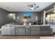 Modern living room with a large sectional and a mounted television at 4413 W Phalen Dr, New River, AZ 85087