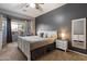 Spacious main bedroom boasts a bay window, soft carpet, and a neutral color scheme for a serene atmosphere at 4413 W Phalen Dr, New River, AZ 85087