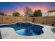 Backyard pool with waterfall feature and desert landscaping, creating a tranquil outdoor retreat at 4413 W Phalen Dr, New River, AZ 85087