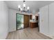 Open dining room with wood flooring, lots of light, and kitchen in background at 4630 N 68Th St # 280, Scottsdale, AZ 85251