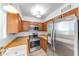 Updated kitchen with stainless steel appliances, wood cabinets, and granite countertops at 4630 N 68Th St # 280, Scottsdale, AZ 85251