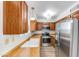 Updated kitchen with stainless steel appliances, wood cabinets, and granite countertops at 4630 N 68Th St # 280, Scottsdale, AZ 85251