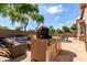 Backyard boasts an outdoor kitchen, comfortable seating, and a pool with a waterfall at 4662 S Calico Rd, Gilbert, AZ 85297