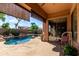 Covered patio showcases the outdoor view of the private pool and serene landscaping at 4662 S Calico Rd, Gilbert, AZ 85297