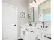 Bathroom with double sink vanity, modern fixtures, and white cabinetry at 4662 S Calico Rd, Gilbert, AZ 85297