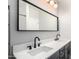 Bathroom with dual sinks, large mirror, and modern black fixtures at 4662 S Calico Rd, Gilbert, AZ 85297