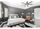 Bedroom features a black accent wall, ceiling fan, and hardwood flooring at 4662 S Calico Rd, Gilbert, AZ 85297