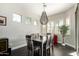 Bright dining room featuring modern lighting, dark wood floors, and light grey walls with large windows at 4662 S Calico Rd, Gilbert, AZ 85297