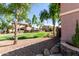 Cozy, single story house with a view of the community green space with mature trees and desert landscaping at 4662 S Calico Rd, Gilbert, AZ 85297