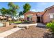 Charming single-story home with desert landscaping, green trees and a well-manicured lawn in the neighborhood at 4662 S Calico Rd, Gilbert, AZ 85297