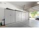 Well-organized garage with ample storage cabinets along the wall at 4662 S Calico Rd, Gilbert, AZ 85297