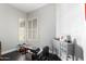 Home gym features ample natural light with a gray console and dark flooring at 4662 S Calico Rd, Gilbert, AZ 85297