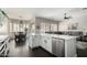 Open concept kitchen featuring white cabinets, quartz countertops and stainless steel appliances adjacent to living spaces at 4662 S Calico Rd, Gilbert, AZ 85297