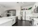 Bright kitchen with white cabinets, stainless steel appliances, quartz countertops, and dark wood floors at 4662 S Calico Rd, Gilbert, AZ 85297
