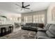 Open-concept living room with a gray sectional sofa and hardwood flooring at 4662 S Calico Rd, Gilbert, AZ 85297