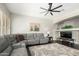 Comfortable living room with a large gray sectional sofa, modern ceiling fan, and neutral paint at 4662 S Calico Rd, Gilbert, AZ 85297