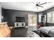 Main bedroom features a modern ceiling fan, dark walls, wood-look flooring and a sliding glass door at 4662 S Calico Rd, Gilbert, AZ 85297
