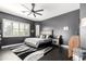 Aesthetic main bedroom with dark walls, an area rug, wood-look flooring, and a modern ceiling fan at 4662 S Calico Rd, Gilbert, AZ 85297