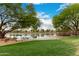 Scenic pond view with lush green lawn and trees, offering a tranquil setting at 4662 S Calico Rd, Gilbert, AZ 85297